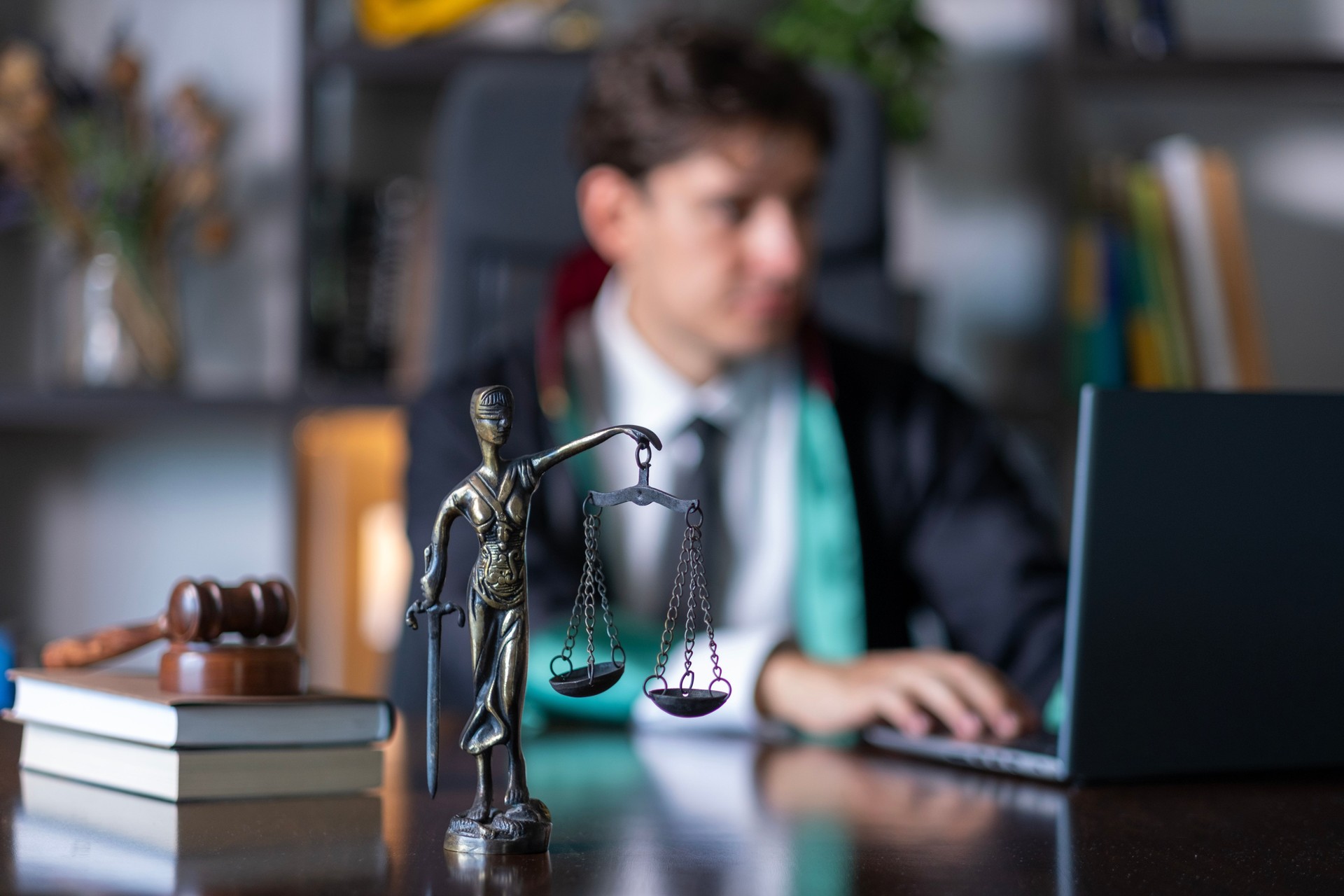 Young lawyer in robe works overtime in his office